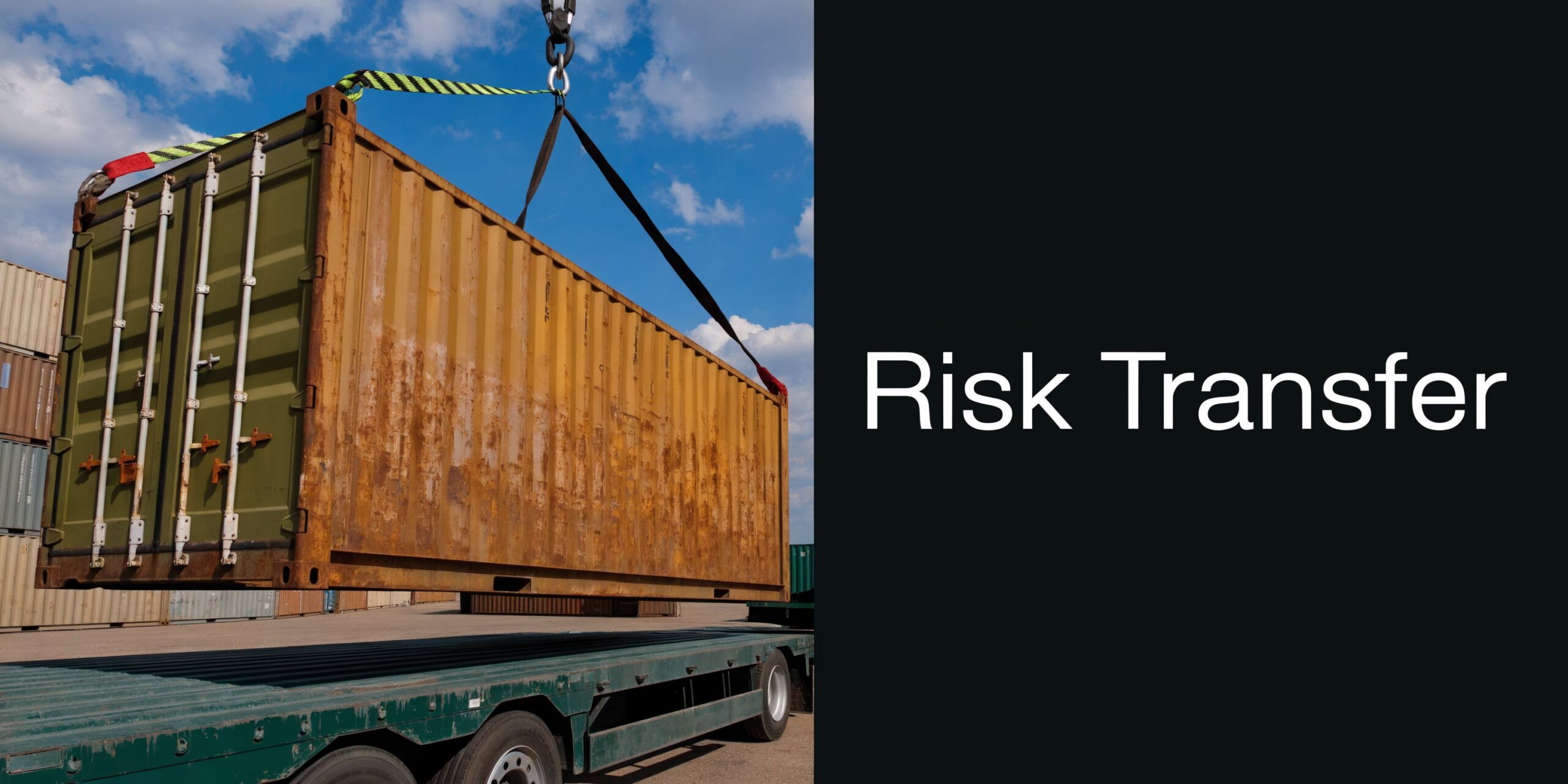 A large rusty shipping container being lifted by a crane onto a flatbed trailer outdoors.