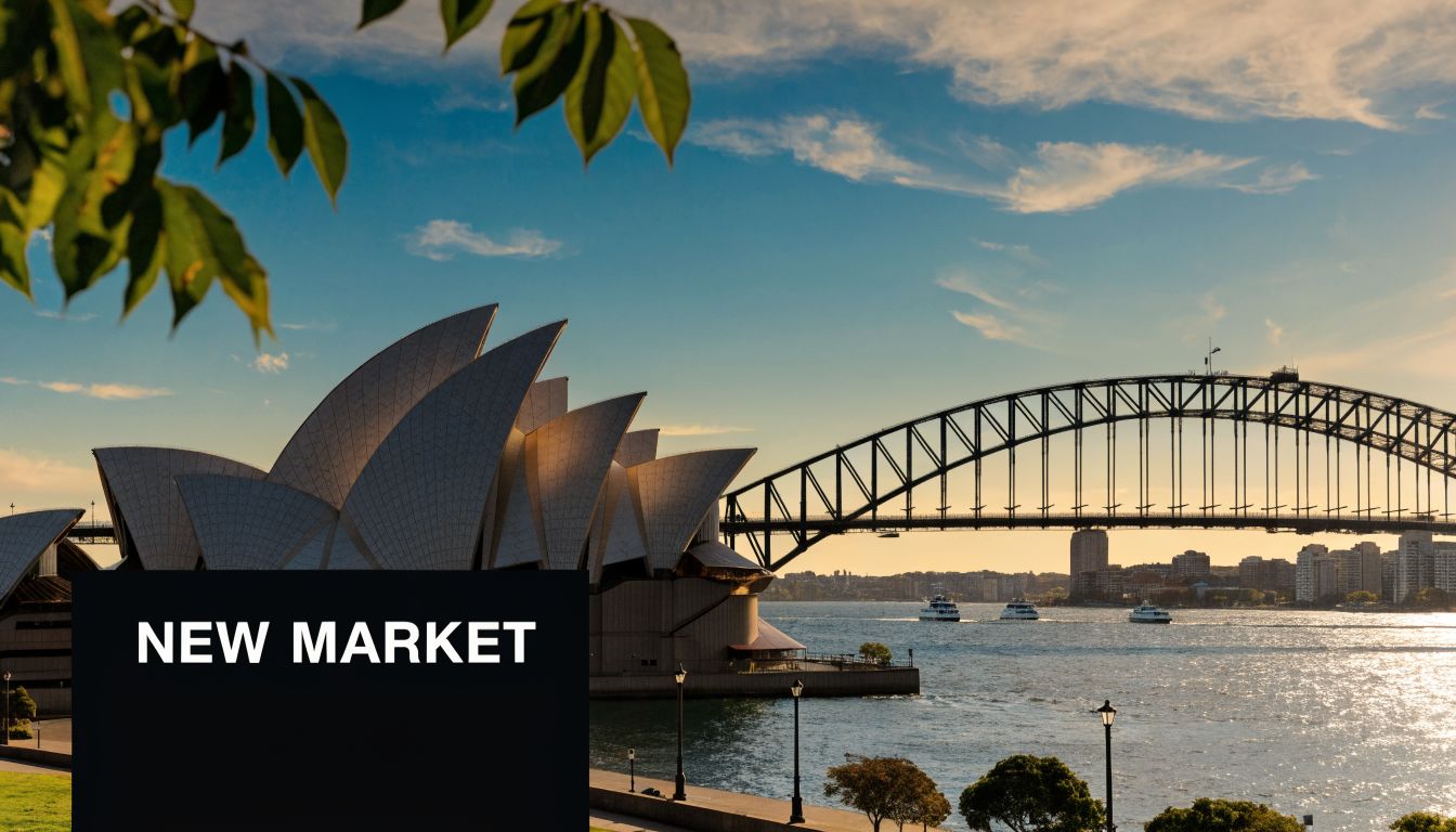 A scenic view of the Sydney Opera House and Harbour Bridge at sunset across the water.